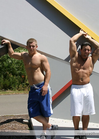 Muscular gay studs Tommy D & Hoyce flaunting their mighty chests outdoors