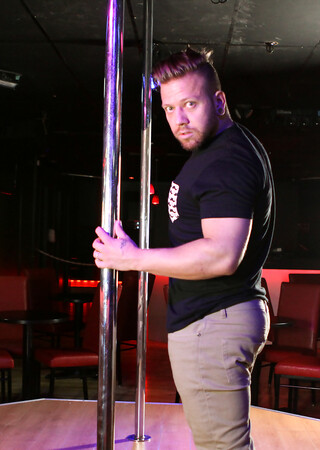 Mam dances in a night club around a pole and shows off his big dick